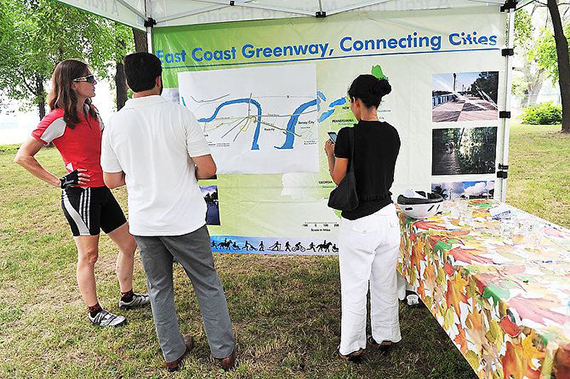 People looking at a banner about the East Coast Greenway